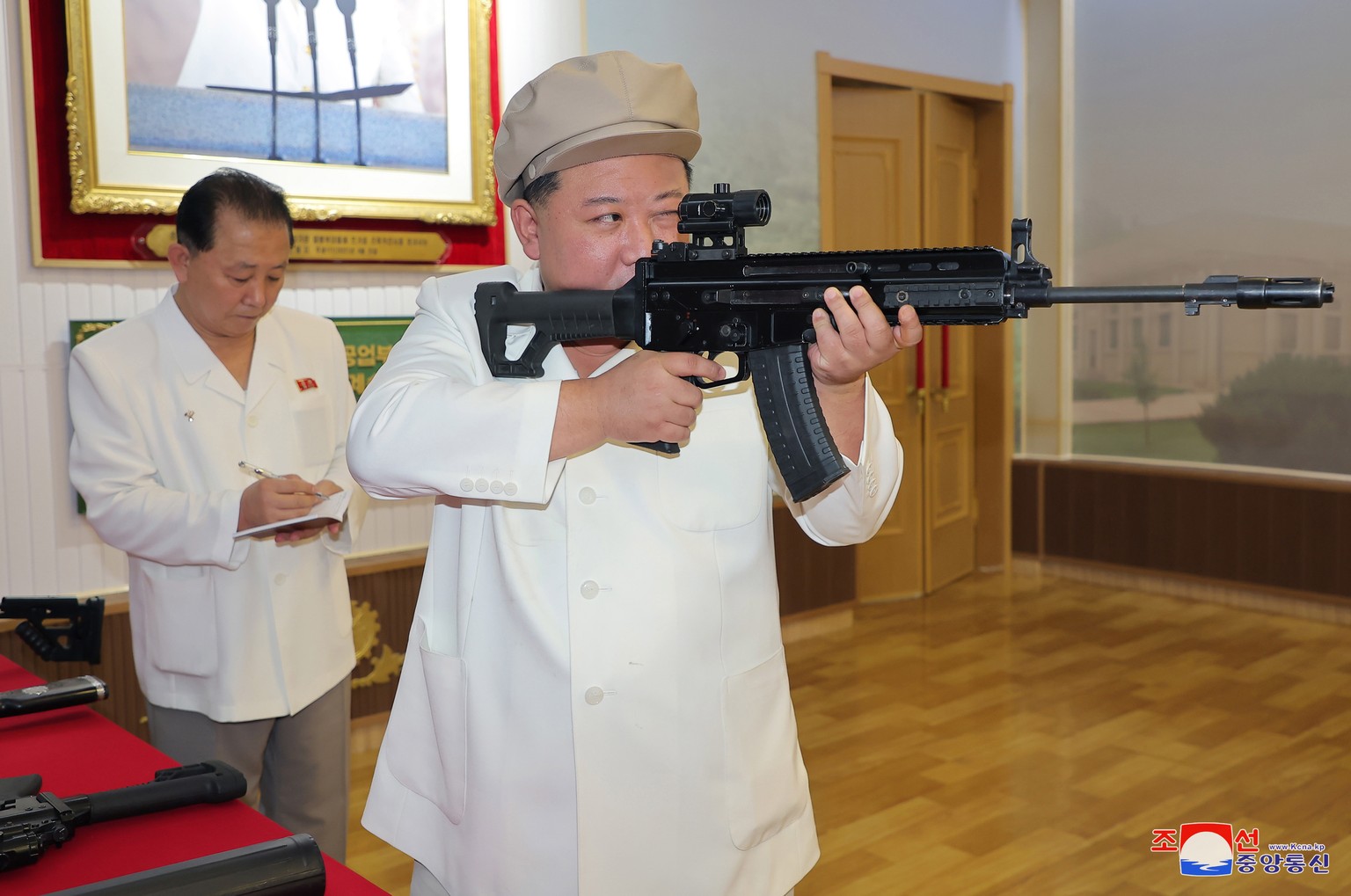 epaselect epa10787050 An undated photo released by the official North Korean Central News Agency (KCNA) on 06 August 2023 shows North Korean leader Kim Jong Un holding a weapon during an inspection of ...