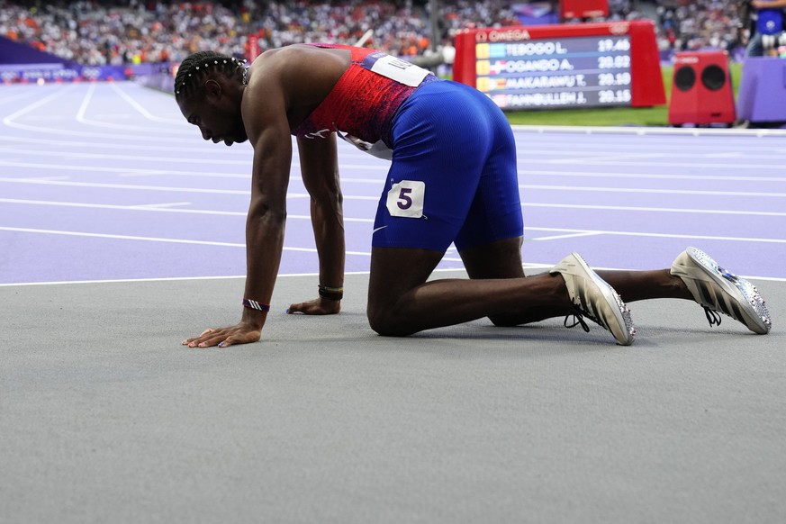 Noah Lyles, of the United States, rests on the track following the men&#039;s 200-meters final at the 2024 Summer Olympics, Thursday, Aug. 8, 2024, in Saint-Denis, France.(AP Photo/Petr David Josek)