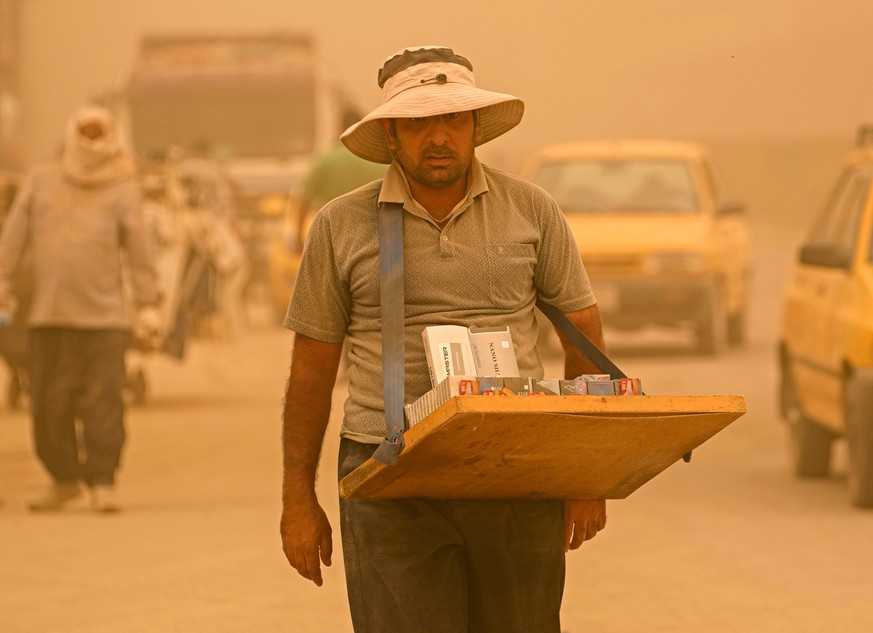 A street vendor sells cigarettes during a sandstorm in Baghdad, Iraq, Monday, May 16, 2022. (AP Photo/Hadi Mizban)