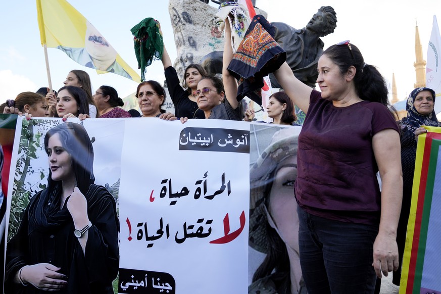 FILE - Kurdish women activists hold headscarfs and a portrait of Iranian woman Mahsa Amini, with Arabic that reads, &quot;The woman is life, don&#039;t kill the life,&quot; during a protest against he ...