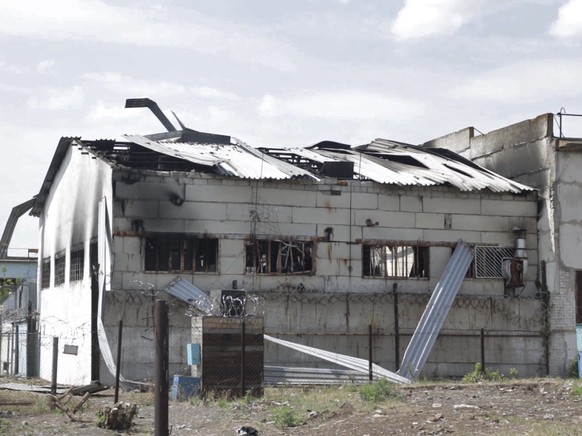 FILE - In this photo taken from video a view of a destroyed barrack at a prison in Olenivka, in an area controlled by Russian-backed separatist forces, eastern Ukraine, on July 29, 2022. Russia and Uk ...