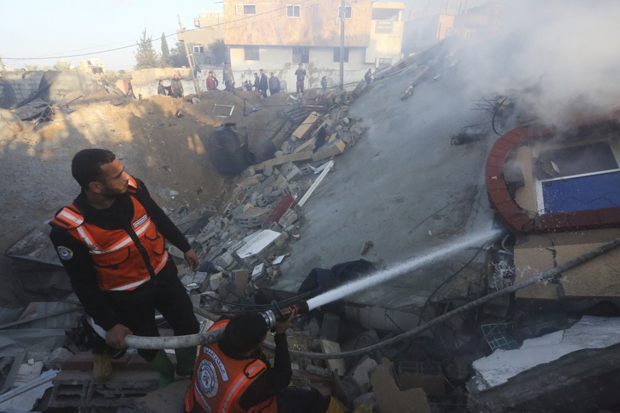 Palestinian emergency hose flames after an Israeli strike on a residential building in Rafah, Monday, Feb. 19, 2024. (AP Photo/Hatem Ali)
