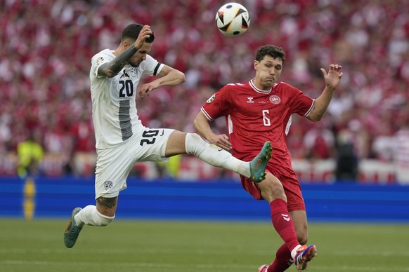 Slovenia&#039;s Petar Stojanovic, left, and Denmark&#039;s Andreas Christensen fight for the ball during a Group C match between Slovenia and Denmark at the Euro 2024 soccer tournament in Stuttgart, G ...