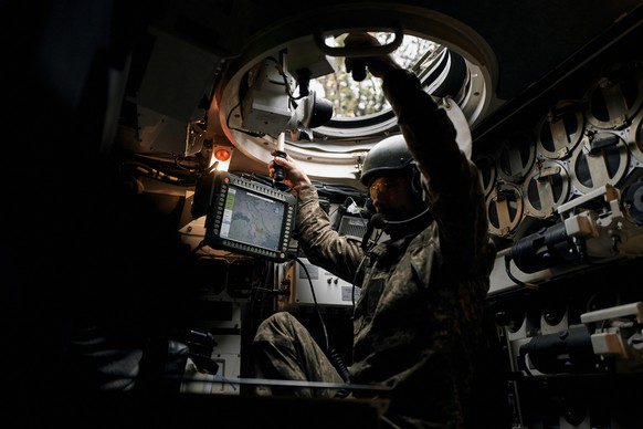 A Ukrainian serviceman drives a Polish howitzer AHS Krab in Donetsk region, Ukraine, Thursday, Oct. 20, 2022. (AP Photo/LIBKOS)