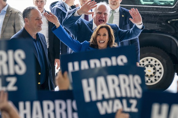 epa11554470 US Vice President and presumptive Democratic Presidential nominee Kamala Harris (R), her running mate Tim Walz (C) and Second Gentleman Doug Emhoff (L) greet supporters prior to a campaign ...