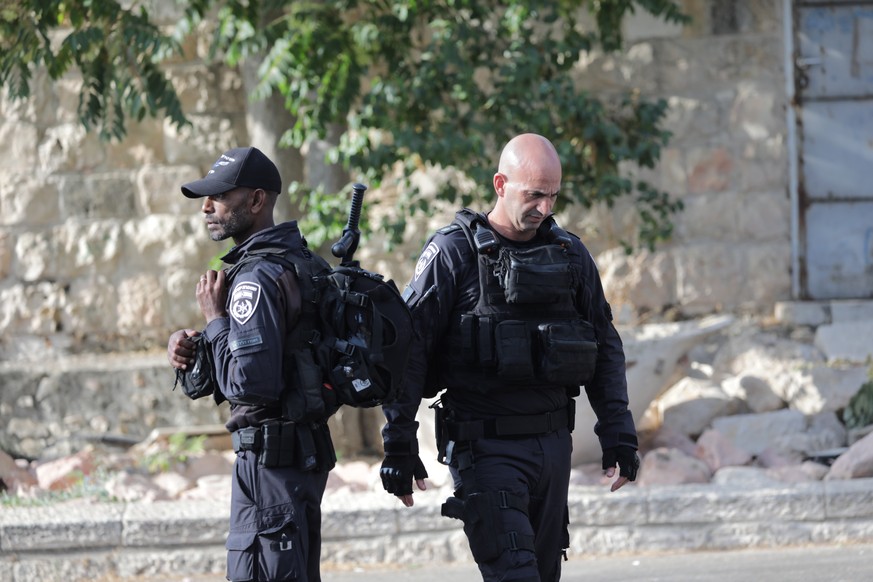 epa10120093 Israeli border police gather near the scene where a shooting took place overnight near the Western Wall, outside the Old City of Jerusalem, Israel, 14 August 2022. A gunman opened fire at  ...