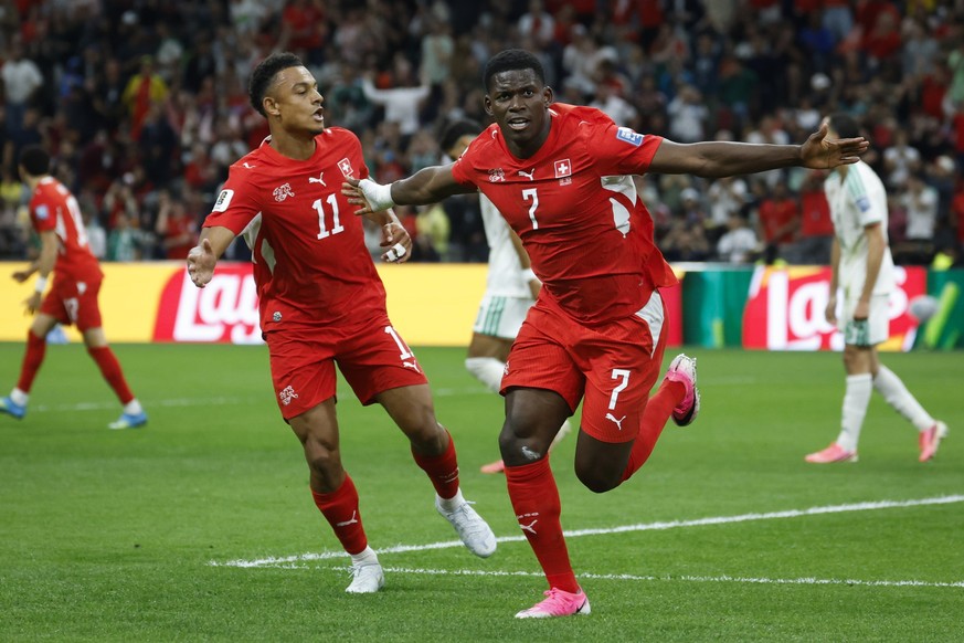 Switzerland's Breel Embolo celebrates with teammate Dan Ndoye scoring his side's first goal during the World Cup round of 32 soccer match between Switzerland and Algeria at the BC Place stad ...