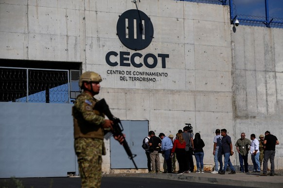 FILE PHOTO: A Salvadoran soldier stands guard, as the CECOT logo is seen, during a media tour at the Terrorism Confinement Center (CECOT) prison, in Tecoluca, El Salvador April 4, 2025. REUTERS/Jose C ...