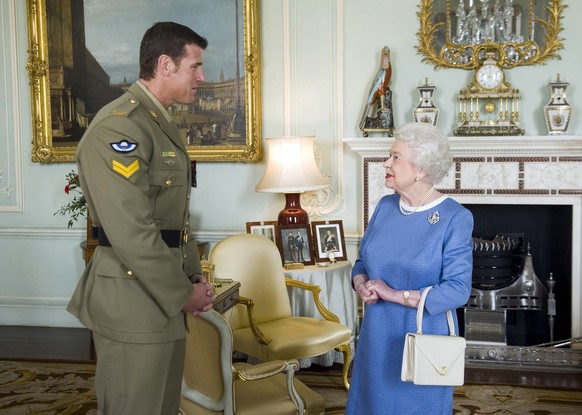 FILE - Britain's Queen Elizabeth II greets Corp. Ben Roberts-Smith from Australia, who was recently awarded the Victoria Cross, during an audience at Buckingham Palace in London, Nov. 15, 2011. ( ...