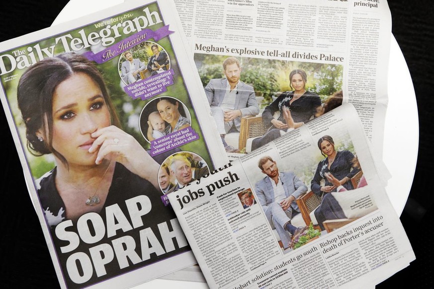 Australian newspapers report in Sydney, Tuesday, March 9, 2021, on an interview of The Duke and Duchess of Sussex by Oprah Winfrey. (AP Photo/Rick Rycroft)