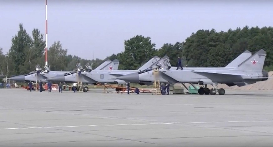 In this handout photo taken from video released by Russian Defense Ministry Press Service on Thursday, Aug. 18, 2022, three MiG-31 fighter jets of the Russian air force stand after lending at the Chka ...