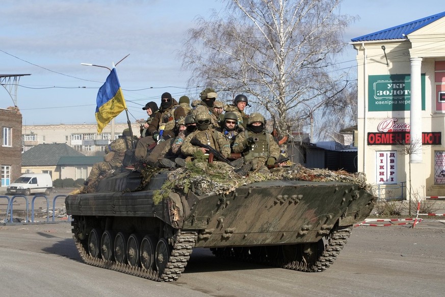 Ukrainian soldiers ride a tank through the town of Trostsyanets, some 400 km eastern of capital Kyiv, Ukraine, Monday, March 28, 2022. The more than month-old war has killed thousands and driven more  ...