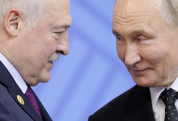 Russian President Vladimir Putin, right, greets Belarusian President Alexander Lukashenko during an official welcoming ceremony for delegations&#039; heads at the BRICS summit in Kazan, Russia, Wednes ...