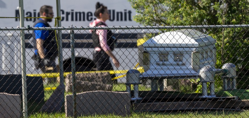 Law enforcement personnel work at the scene of a shooting Thursday, June 2, 2022 at Graceland Cemetery in Racine, Wis. Police say a shooting at a cemetery south of Milwaukee Thursday afternoon resulte ...