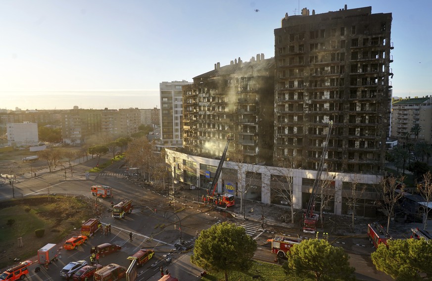Firefighters work at a burned block building in Valencia, Spain, Friday, Feb. 23, 2024. A fire has engulfed two residential buildings in the eastern Spanish city of Valencia, killing at least four peo ...