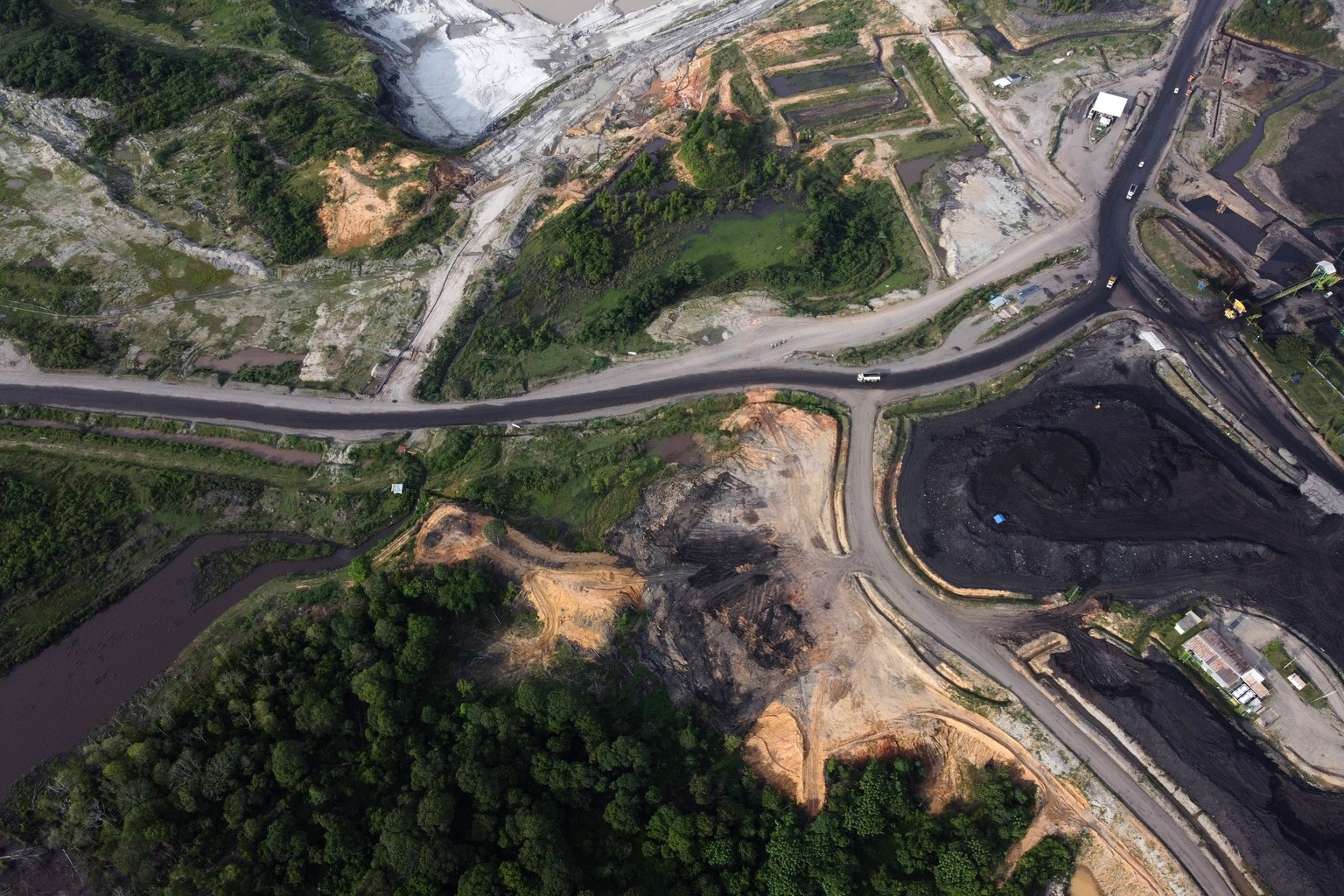 epa12875071 An aerial picture taken with a drone shows the coal mining at the edge of Aceh protected forest in West Aceh, Indonesia, 08 April 2026. According to Auriga Nusantara, an Indonesian non-gov ...