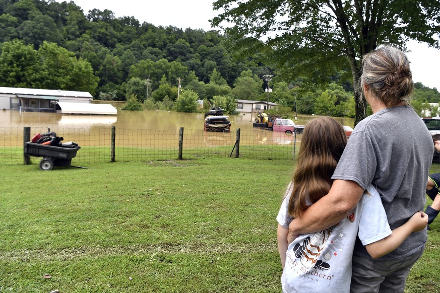 Bonnie Combs, right, hugs her 10-year-old granddaughter Adelynn Bowling watches as her property becomes covered by the North Fork of the Kentucky River in Jackson, Ky., Thursday, July 28, 2022. Flash ...