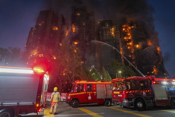 Firefighters work to extinguish a fire which broke out at Wang Fuk Court, a residential estate in the Tai Po district of Hong Kong&#039;s New Territories, Wednesday, Nov. 26 2025. (AP Photo/Chan Long  ...