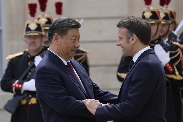 French President Emmanuel Macron, right, welcomes China&#039;s President Xi Jinping before their meeting at the Elysee Palace, Monday, May 6, 2024 in Paris. French President Emmanuel Macron is welcomi ...
