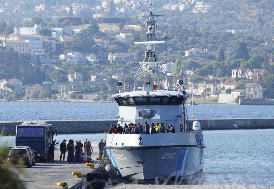 FILE - Migrants disembark from a Greek coast vessel after a rescue operation, at the port of Mytilene, on the northeastern Aegean Sea island of Lesbos, Greece, Monday, Aug. 28, 2023. European Union na ...