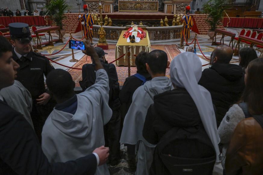 In this image released on Monday, Jan. 2, 2023, by the Vatican Media news service, the body of late Pope Emeritus Benedict XVI is lied out in state inside St. Peter's Basilica at The Vatican wher ...