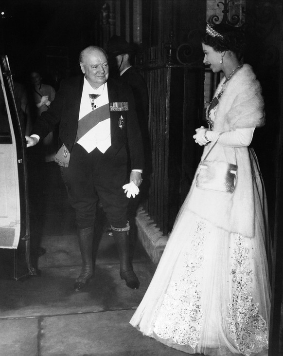 FILE - British Prime Minister Sir Winston Churchill, wearing knee breeches, garter and garter sash, holds the car door for Queen Elizabeth II after being host at a farewell dinner for the Queen and fo ...