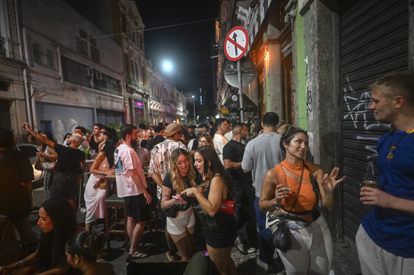 People enjoy the outdoor area of Destilaria Maravilha bar on Senado street in Lapa, Rio de Janeiro, Brazil, on December 13, 2025.