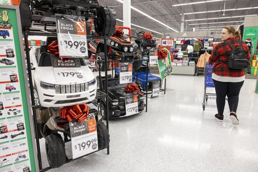 A Black Friday shopper looks for a deal on toy cars at Academy Sports + Outdoors in Covington, La., on Friday, Nov. 26, 2021. Retailers are expected to usher in the unofficial start to the holiday sho ...