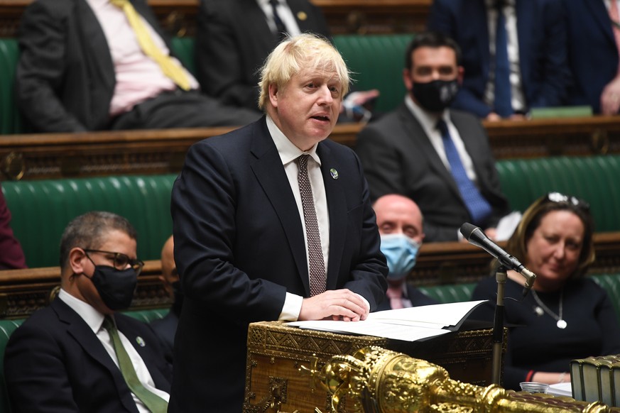 epa09584060 A handout photograph released by the UK Parliament shows British Prime Minister Boris Johnson delivers a statement on the UN Climate Change Conference COP26 at parliament in London, Britai ...