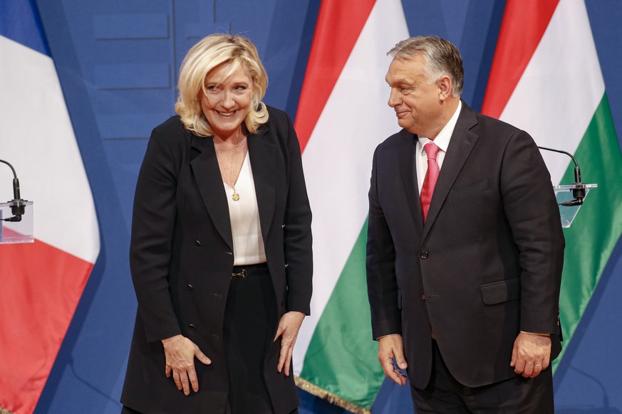 French far-right leader Marine le Pen, left, shares a smile with Hungarian Prime Minister Viktor Orban after a joint press conference in Budapest, Hungary, Tuesday, Oct. 26, 2021. (AP Photo/Laszlo Bal ...