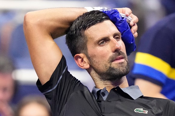 Novak Djokovic, of Serbia, cools off during a match against Mariano Navone, of Argentina, in the first round of the U.S. Open tennis championships Sunday, Aug. 30, 2026, in New York. (AP Photo/Frank F ...
