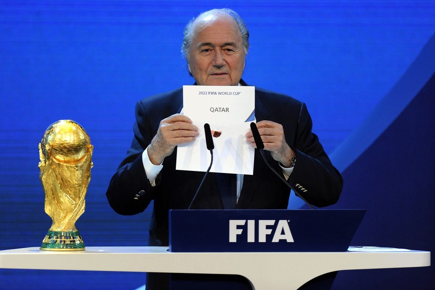 FILE - FIFA President Joseph S. Blatter announces that Qatar will be hosting the 2022 Soccer World Cup, on Thursday, Dec. 2, 2010, during the FIFA 2018 and 2022 World Cup Bid Announcement in Zurich, S ...
