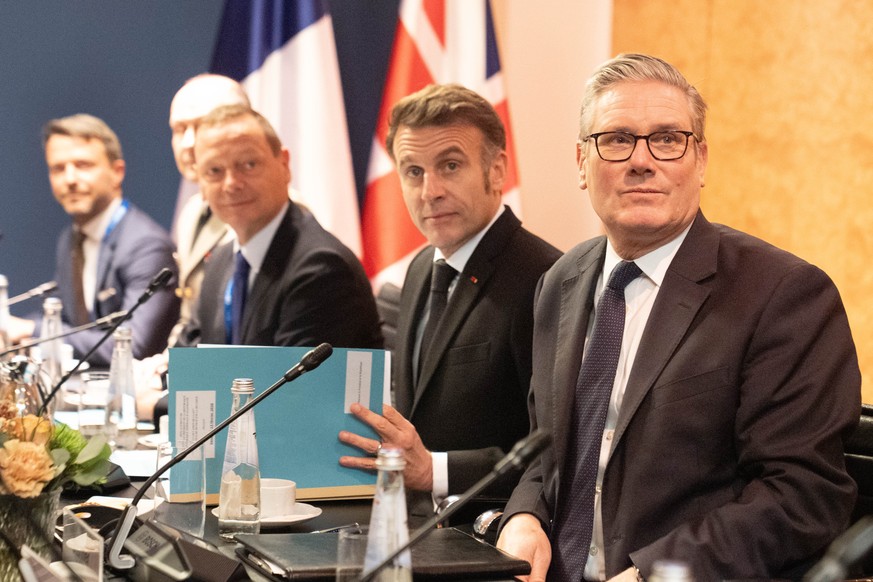 Britain's Prime Minister Keir Starmer, right, attends a trilateral meeting with German Chancellor Freidrich Merz, not pictured, and French President Emmanuel Macron, second right, at the Munich S ...