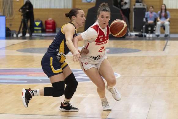 Switzerland&#039;s Evita Herminjard, right, fights for the ball with Bosnia-Herzegovina&#039;s Amna Kahric, during the FIBA EuroBasket 2025 Qualifier basketball game between Switzerland and Bosnia-Her ...