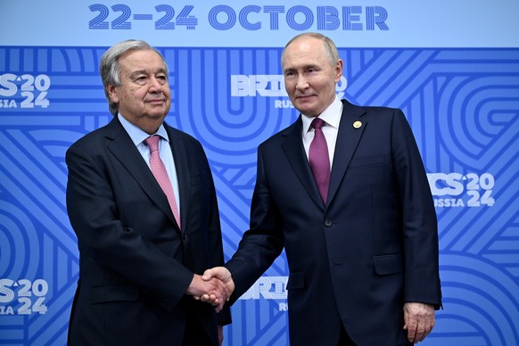 epa11681492 Russian President Vladimir Putin (R) greets United Nations (UN) Secretary General Antonio Guterres during their bilateral meeting on the sidelines of the BRICS summit in Kazan, Russia, 24  ...