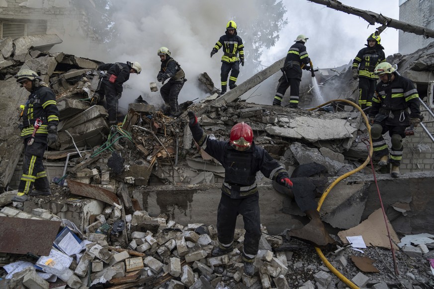 Rescue workers clearing rubble of a destroyed school after an attack in Kharkiv, Ukraine, on Monday, July 4, 2022. The Ukrainian military&#039;s General Staff says that Russian forces are trying to pr ...