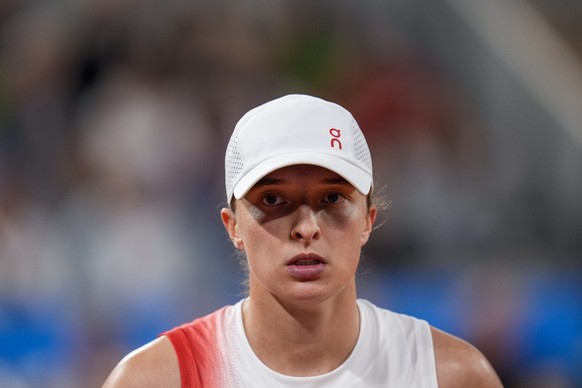 FILE - Iga Swiatek of Poland looks on during her match against Irina-Camelia Begu of Romania during a women&#039;s singles tennis competition, at the 2024 Summer Olympics, Saturday, July 27, 2024, in  ...