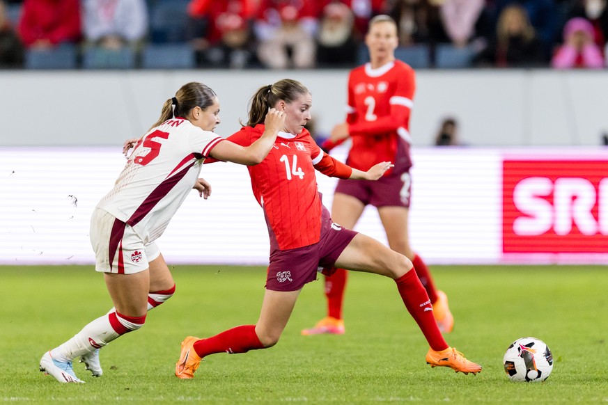 Smilla Vallotto of Switzerland, right, competes with Emma Regan of Canada during the women&#039;s international friendly soccer match between Switzerland and Canada at the Swissporarena, in Lucerne, S ...