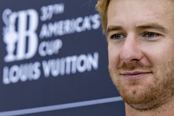 Cyclist Barnabe Delarze of Switzerland&#039;s Alinghi Red Bull Racing team speaks with journalists during the first Round Robin Challenger Series of the Louis Vuitton Cup at the 37th America&#039;s Cu ...