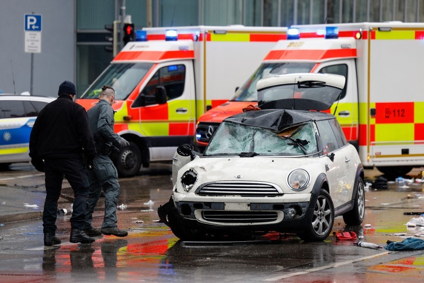 Members of the emergengy services work at the scene where a car drove into a crowd in the southern German city of Munich on February 13, 2025 leaving several people injured, police said. Munich police ...