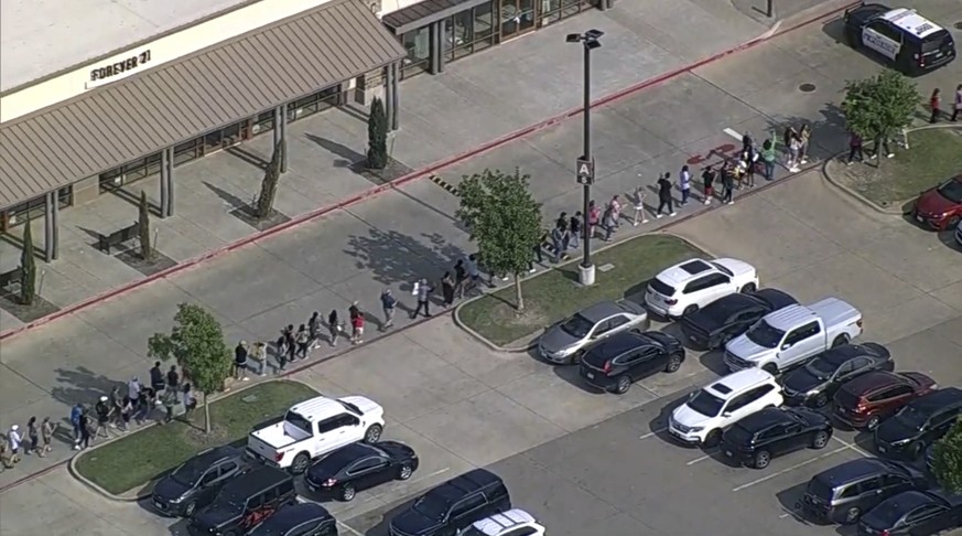 In this frame grab from video provided by WFAA, people are evacuated from Allen Premium Outlet, Saturday, May 6, 2023, in Allen, Texas. Law enforcement responded to reports of a shooting at the outlet ...