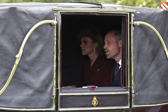 Britain&#039;s William, Prince of Wales, and Kate, Princess of Wales, ride in the Semi-State Landau towards Windsor Castle, in Windsor, England, Wednesday, Sept. 17, 2025. (Henry Nicholls/Pool Photo v ...