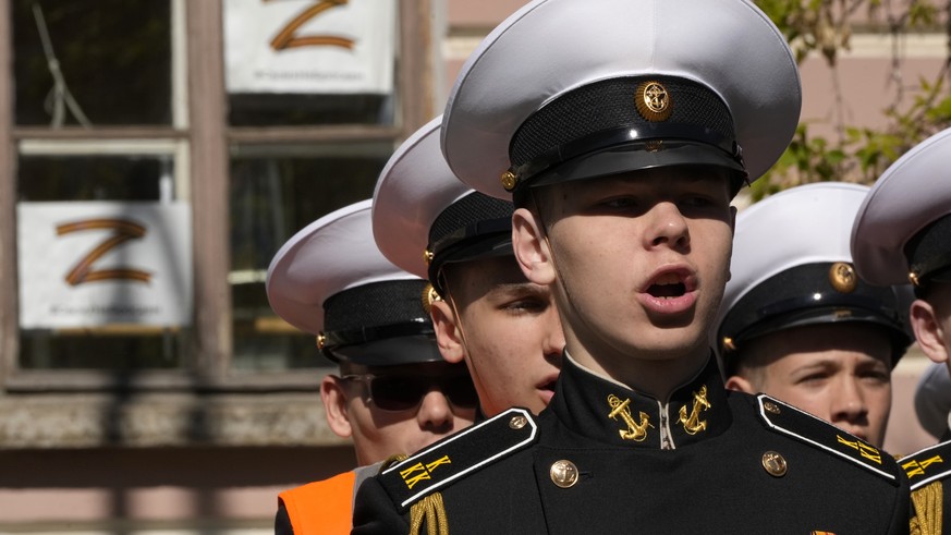 Navy school cadets attend celebrations marking 318th anniversary of the city of Kronstadt, outside St. Petersburg, Russia, Saturday, May 21, 2022, with sheets depicting letter Z, which has become a sy ...