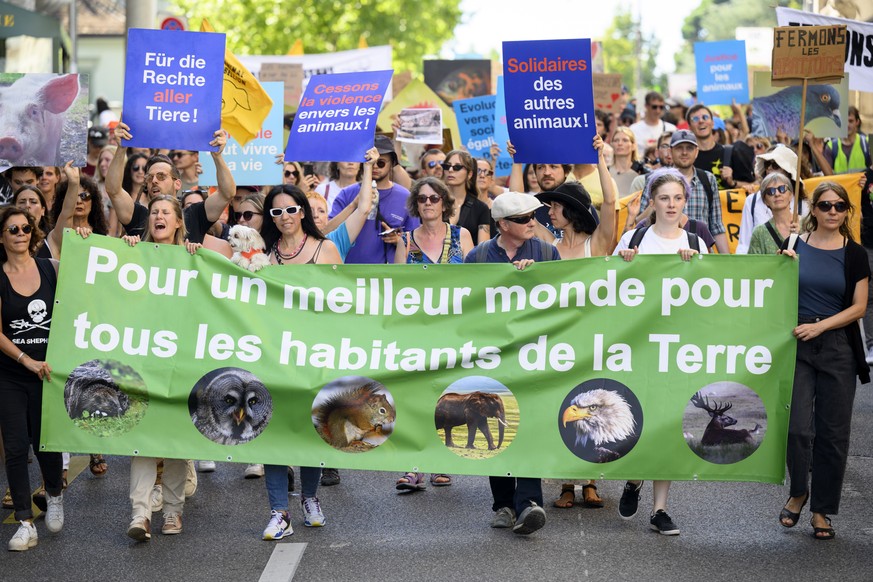epa10141708 Anti-speciesism activists hold banners and posters, during a march for the 8th World Day for the End of Speciesism (WoDES), in Lausanne, Switzerland, 27 August 2022. The World Day for the  ...