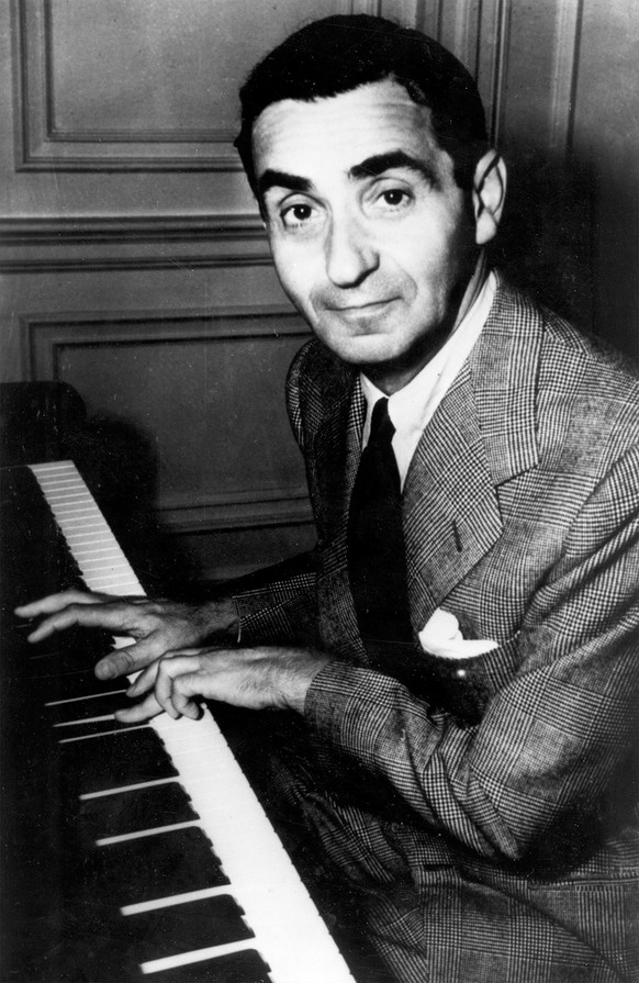 FILE in this undated file photo, composer Irving Berlin plays the piano. A U.S. Army division that included Berlin among its ranks started mustering on Long Island a century ago this weekend during Wo ...