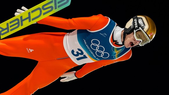 Gregor Deschwanden, of Switzerland, soars through the air during his first round jump of the ski jumping men's normal hill individual at the 2026 Winter Olympics, in Predazzo, Italy, Monday, Feb. ...