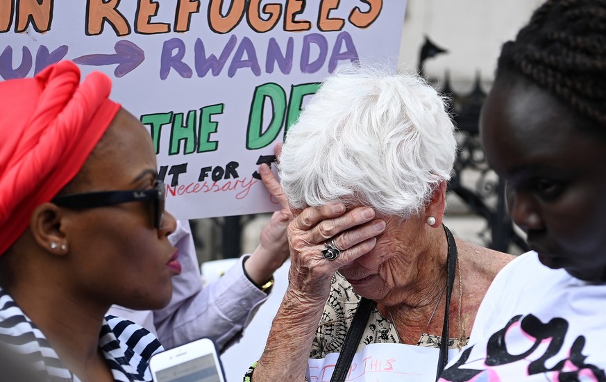 epaselect epa10011033 Human rights campaigners react after losing an appeal outside the High Court in London, Britain, 13 June 2022. An Appeal Court judge has ruled against stopping the UK Home Office ...