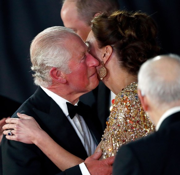 LONDON, UNITED KINGDOM - SEPTEMBER 28: (EMBARGOED FOR PUBLICATION IN UK NEWSPAPERS UNTIL 24 HOURS AFTER CREATE DATE AND TIME) Prince Charles, Prince of Wales kisses Catherine, Duchess of Cambridge as  ...