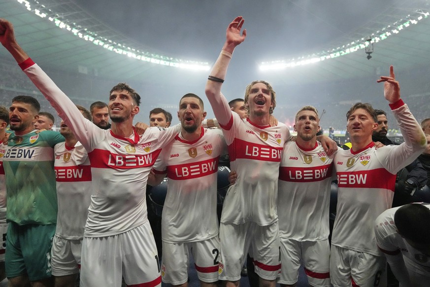 VfB Stuttgart players celebrate after winning the trophy in the German soccer cup, DFB Pokal, final match between Arminia Bielefeld and VfB Stuttgart at Olympiastadion in Berlin, Germany, Saturday, Ma ...
