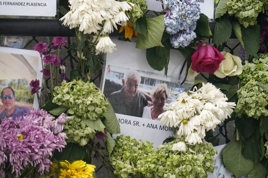 This June 29, 2021, photo shows a memorial wall for the victims of the Champlain Towers South building collapse in Surfside, Fla., with a photo of Juan Mora Sr. and his wife, Ana Mora. (AP Photo/Geral ...